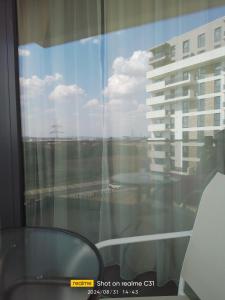 a window with a view of a building at Avangarde de Lux Apartment in Seleuş