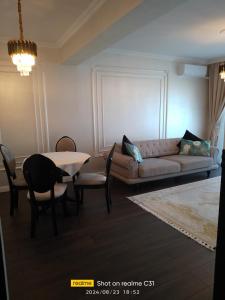 a living room with a couch and a table at Avangarde de Lux Apartment in Seleuş