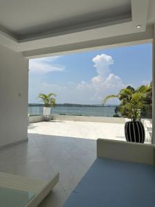 a living room with a view of the ocean at Infinity Pool Villas, Entebbe airport shuttle, free parking large private pool Wifi 24 hr security in Entebbe