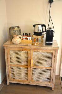 un mobiletto di legno con una macchina per il caffè e un tostapane di Bed & Breakfast Puur Natuur Putten, met privé sauna a Putten