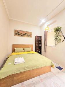 a bedroom with a bed with a towel on it at Azalea Apartment in Hanoi