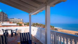 a balcony with a table and chairs and the ocean at DENITH Rooftop in Neoi Epivates