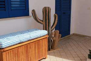 a bed in a room next to a cactus at B&B Santa Maria Di Leuca in Leuca