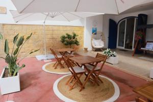 a table and chairs in a room with plants at B&B Santa Maria Di Leuca in Leuca