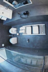 a bathroom with a glass counter top and toilets at WE LOVE ROMA Guest House in Rome