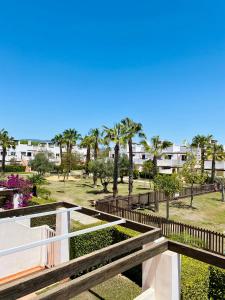 a view of a park with palm trees and buildings at Condado de Alhama, Jardin 11 in Alhama de Murcia +25 photos