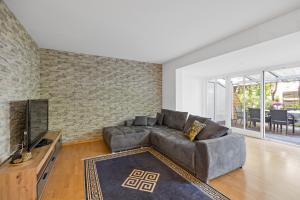 Una sala de estar con un sofá y un televisor. en 3 Zimmer EG Wohnung in Stephanskirchen, en Stephanskirchen