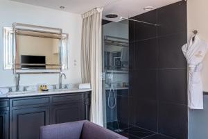 a bathroom with a shower and a sink at La Villa Mauresque in Saint-Raphaël