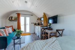 une chambre avec un lit et une cuisine avec une table dans l'établissement NEW The Paddocks Pod Selside - Thorn, à Lake District National Park