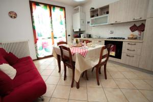 a kitchen with a table and a red couch at Guest House Onde Chiare in Reggio Emilia +13 photos