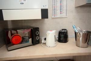 a kitchen counter with a toaster and a microwave on it at Guest House Onde Chiare in Reggio Emilia