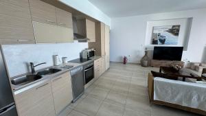 A kitchen or kitchenette at NV seafront villa Aegina 1