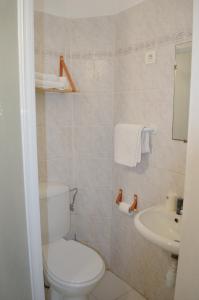 a bathroom with a toilet and a sink at Hôtel du Parc - Bastide provençale in Draguignan +30 photos
