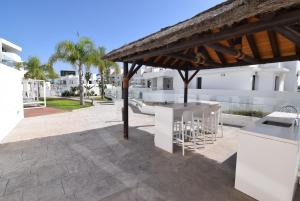 a patio with a gazebo next to some buildings at Dream Gardens 2 in Mijas Costa