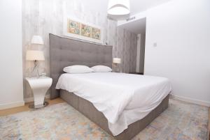 a bedroom with a large bed with white sheets and pillows at Dream Gardens 2 in Mijas Costa +18 photos