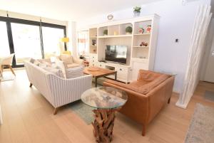 a living room with two couches and a tv at Dream Gardens 2 in Mijas Costa