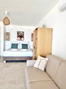 a living room with a couch and a bed at Suite Balnéo Canet in Canet-en-Roussillon +36 photos