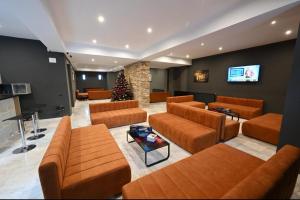a living room with brown couches and a christmas tree at R&B Apartment 24 in Predeal