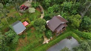 an aerial view of a house with a tractor at Casta Wild Resort in Batheri +14 photos