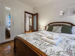 a bedroom with a large bed with two pillows on it at Bike Refuge - WiFi - Free Ticket Museum - Smart TV in Altare