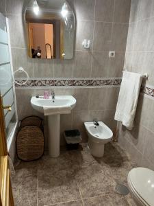 a bathroom with a sink and a toilet and a mirror at VAO Holiday Rentals-Santiago De la Ribera in San Javier +22 photos