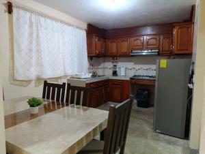 a kitchen with a table and a refrigerator at Atzin 2 in Ixmiquilpan