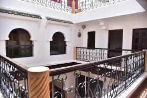 a balcony of a building with a wooden stool at Riad Lily in Rabat