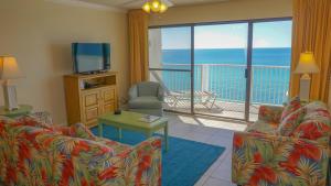 a living room with a view of the ocean at Landmark Holiday Beach, a VRI resort in Panama City Beach