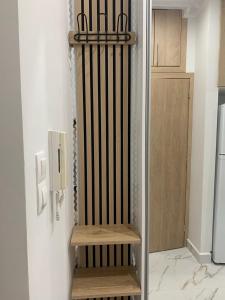 a staircase in a kitchen next to a refrigerator at Loutraki comfortable apartment center 50m from the sea in Loutraki