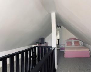 a attic room with a bed and a staircase at RYD HOUSE Bucovina in Frumosu
