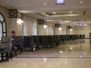 an empty banquet hall with chairs and tables at Al Mukhtara Plaza Hotel - فندق المختارة بلازا in Medina