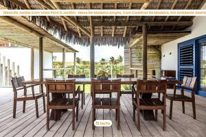 a wooden table and chairs on a deck at Casa Pipa em condomínio de luxo no Fortim in Barra (2)