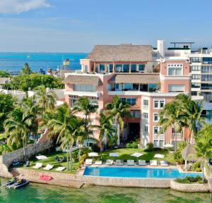an aerial view of a resort with a swimming pool at Casa Tortugas Boutique Hotel - A Hidden Gem in Cancun in Cancún