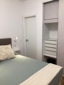 a bedroom with a bed with a dresser and a closet at Casa Giorì Los Cristianos Castle Harbour in Los Cristianos +42 photos