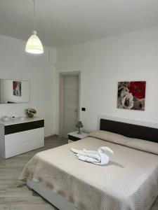 a white bedroom with a bed with a towel on it at Casa Bruna Tettoia in Pimonte +22 photos