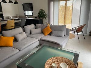 a living room with a couch and a table at Ti Nolgann in Lannilis