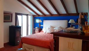 a bedroom with a red bed and blue walls at Az-zait in Aznalcázar +20 photos