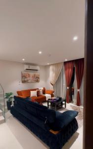 a living room with a large couch in a room at Naseem AlBahar in Muscat +5 photos