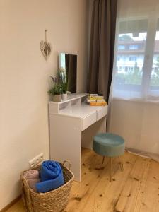 a desk with a chair and a mirror in a room at Eistänzer Nest in Oberstdorf +9 photos