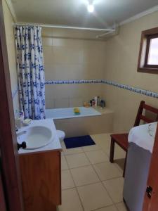 a bathroom with a sink and a tub and a toilet at Family home, panoramic views of lake & countryside in Puerto Rico