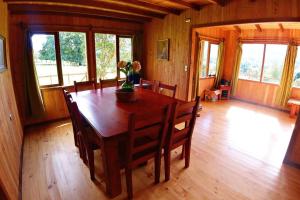 a dining room with a wooden table and chairs at Family home, panoramic views of lake & countryside in Puerto Rico +27 photos