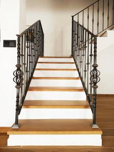 a set of stairs with black and white railings at Casa Rural En Los Trigales in Navas de Oro