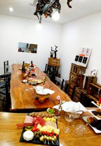 a dining room table with food and wine glasses at Via Eberle - Vinothek und Gästezimmer in Grünstadt