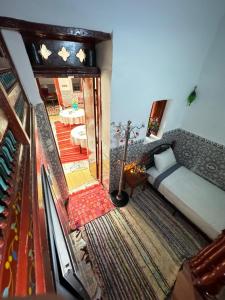 a living room with a bed and a table at Dar Enouiina in Fez