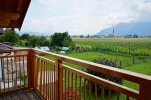 a balcony with a view of a field of crops at Ferienhaus Am Weitfeld - Ruheoase mit Garten & Bergblick nahe Salzburg in Ainring