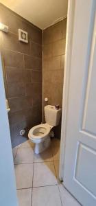 a bathroom with a toilet in a small room at PrJARDIN 06 in Le Blanc-Mesnil +4 photos