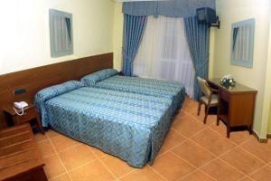 Postel nebo postele na pokoji v ubytování Hostal Castilla