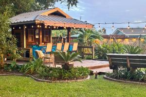 a house with a deck with chairs on it at Lagniappe Retreat in Long Beach