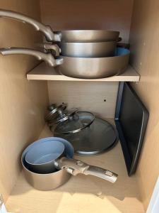 a shelf with some pots and pans in a kitchen at Lagniappe Retreat in Long Beach