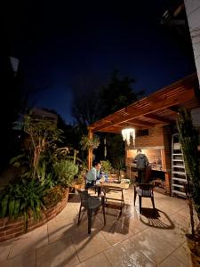 two people sitting at a table in a patio at night at ROOM Ingá Puerto in Colón